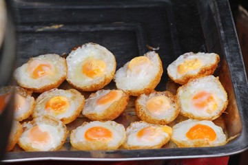 Canvas Print - Quail eggs with sauce in street food