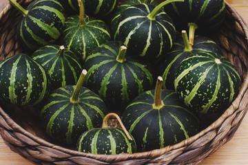 green strange ornamental pumpkins on seasonal farmer`s market