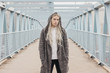 © Evil Pixels  Photography/Stocksy - Handsome male model with long blond hair on the bridge