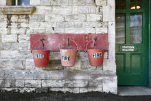 Water Buckets Hanging Outside On The Wall Of Fire Station