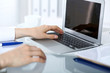 © rogerphoto - Close up of business woman hands typing on laptop computer