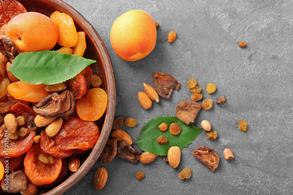 Dried apricots, raisins and nuts in bowl on table