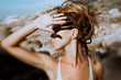 © zolotareva_elina - young woman cover her face with hand outdoors. Photo was taken with lens baby