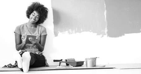 Wall Mural - black female painter sitting on floor