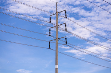 Electricity post with blue cloudless sky