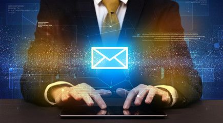 Businessman typing and mailing icon above