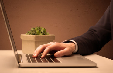 Businessman is suit working on laptop