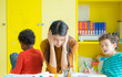 © weedezign - Teacher get headache with two naughty kids in classroom at kindergarten school.