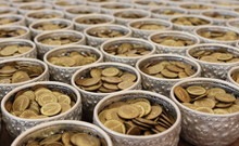 Selective Focus Of Coin Of Buddha In Ridiculously. Many Thai Coins As A Donation On The Buddha Foot Print As A Worship.