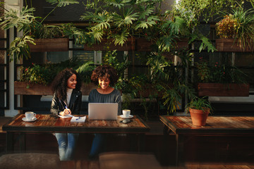 Women discussing ideas over coffee