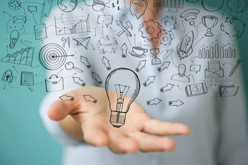 Leinwandbilder - Businesswoman touching and holding sketch lightbulb