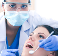 Wall Mural - Woman dentist working at her patients teeth