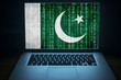 Pakistan internet security.  Laptop with binary computer code and Pakistani flag on the screen. Pakistani hacker. Network security.