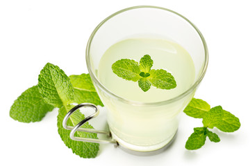 mint tea glass and green leaves isolated on white