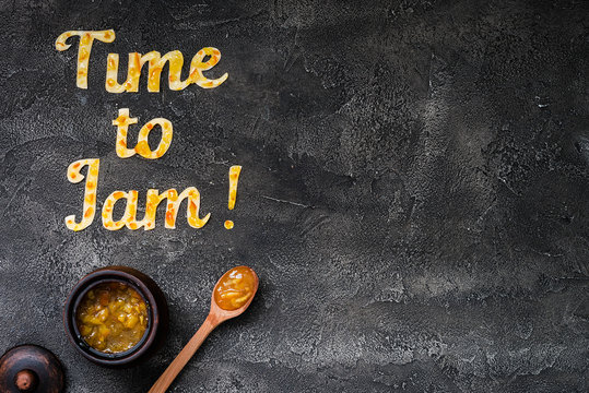 Food typography Time to Jam on dark background with copy space. Orange jam lettering