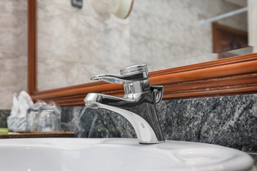 Canvas Print - Water tap and sink in hotel bathroom