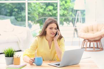 Canvas Print - Young woman working at home