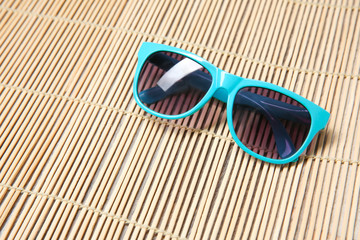 Child's sunglasses on wicker background