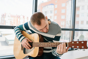 Wall Mural - Learning to play the guitar. Music education.