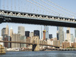 Manhattan Bridge and Brooklyn Bridge with Manhattan skyline background from Brooklyn early in the morning with blue sky and sun shine - Brooklyn, New York, NY, United States of America, USA