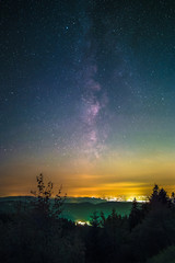 Wall Mural - The Milky Way as seen from the Black Forest High Road near the lake Mummelsee at Seebach in Germany.