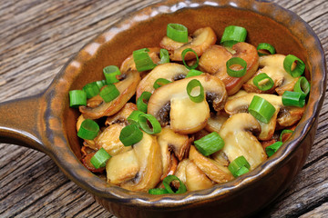 Canvas Print - Champignon with green onion in a pan