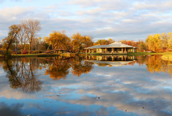 Wall Mural - autumn nature background. beautiful fall landscape in the city park. colored trees and cloudy sky re