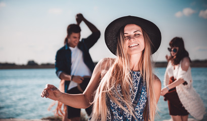 Wall Mural - Group of friends dancing and celebrating on beach, boho party