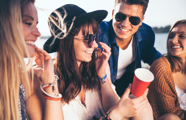 Wall Mural - Friends having fun and enjoying beach festival, youth concept