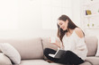 © Prostock-studio - Young smiling woman reading a book