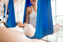 Happy Young Woman Practicing Aero Yoga In Blue Hammock