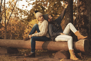 Young and happy couple in the autumn park