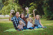© romaset - Young family with advertising signs in the park.