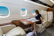 young beautiful woman in Luxury interior in the business jet