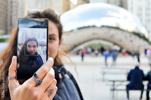 Fotografie, Obraz Tourist taking selfie in front of a landmark in Chicago, Illinoi