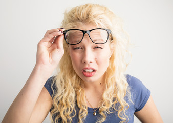 woman with her glasses lifted up can't see