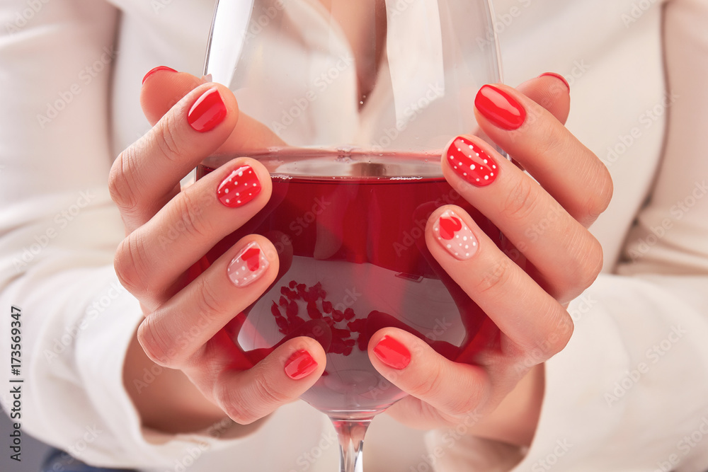 Woman hands holding large glass of wine. Young woman hands with beautiful  red manicure holding glass with red wine. Valentines day nail art design.  Stock Photo | Adobe Stock
