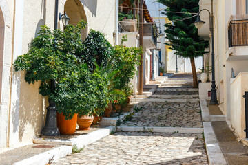 Wall Mural - Street with steps in Sitia town, Crete island, Greece