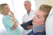 © auremar - close up female patient wearing neck brace and doctors background