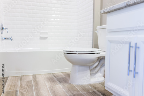 Fotografía Modern white plain clean toilet bathroom, bathtub with shower tiles and hardwood