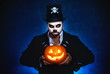 halloween. magic skeleton with  pumpkin. man in makeup and  costume