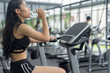 © I Believe I Can Fly - Fitness woman in training drinking water after exercises in gym