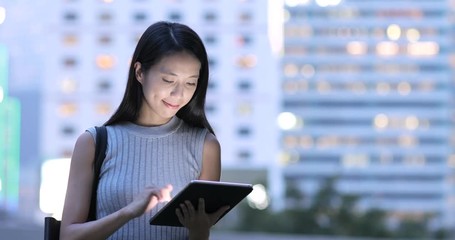 Canvas Print - Woman using tablet computer at night