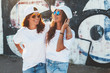© Alena Ozerova - Models wearing plain tshirt and sunglasses posing over street wall