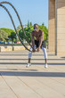 © expressiovisual - male muscular training with battle ropes and training mask