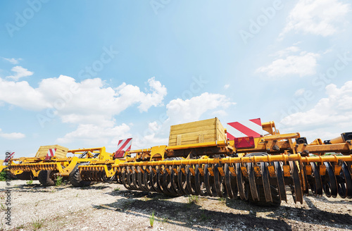 Fotografie, Obraz Close up of seeder attached to tractor in field