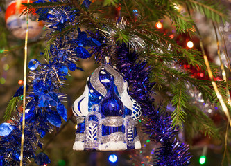  Close-up christmas toy blue and white temple is hanging on the fir tree.