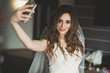 © olegparylyak - Beautiful bride making selfie in the home before wedding
