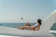 © Raman - The girl lies on the roof of the yacht. Gulls are flying