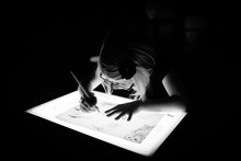 Black And White Of Girl Using A Light-box To Trace A Picture.